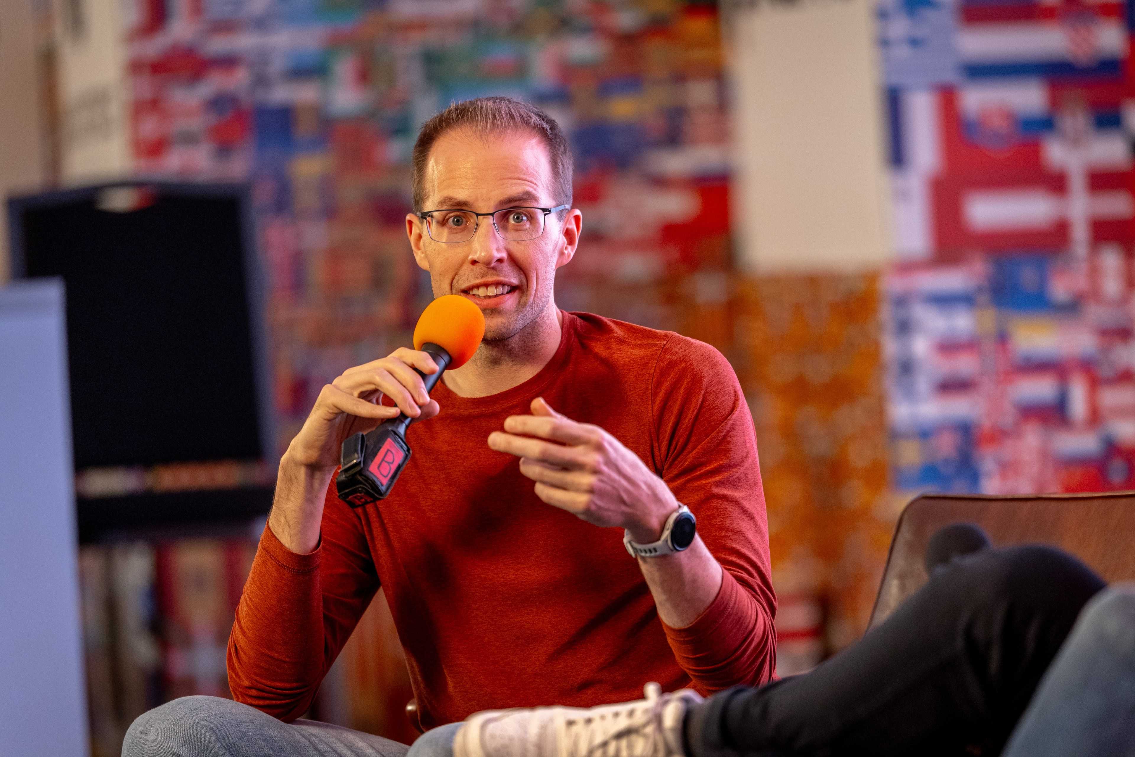 Jim discussing an idea while seated with a microphone